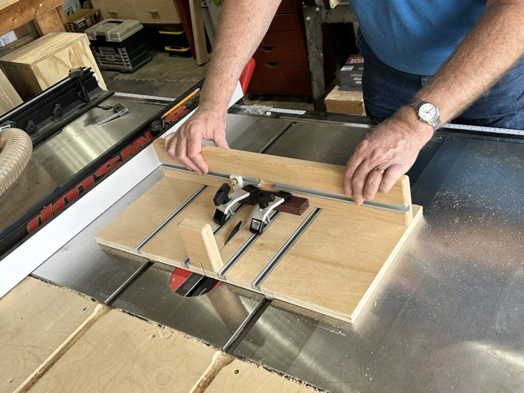 Cutting a purpleheart piece with the small parts crosscut sled on a table saw
